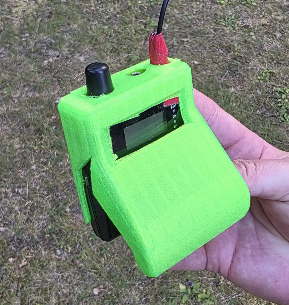 The actual first CrabShell prototype, printed in loud neon green TPU